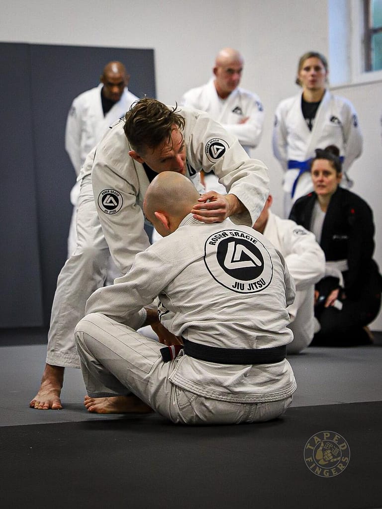 Brazilian Jiu-Jitsu coach demonstrating a technique in Buckingham